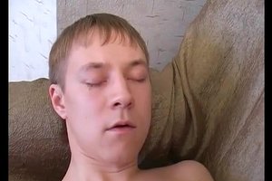 Totally naked handsome guy is lying on bed and masturbating