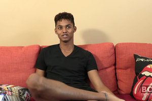 Cheerful athletic ebony guy is showing off his tasty body