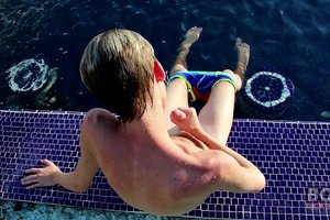 Perverted young guy is wanking his lustful cock in a swimming pool