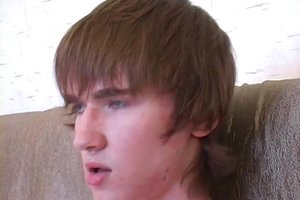 Sexy guy with a tattoo is sitting completely naked and jerking off