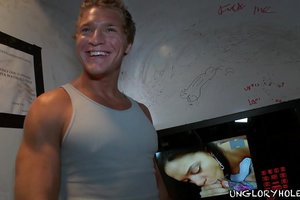 Two athletic guys are facing the wall with hole totally naked