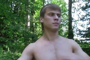 Athletic blonde guy is training and masturbating in the forest